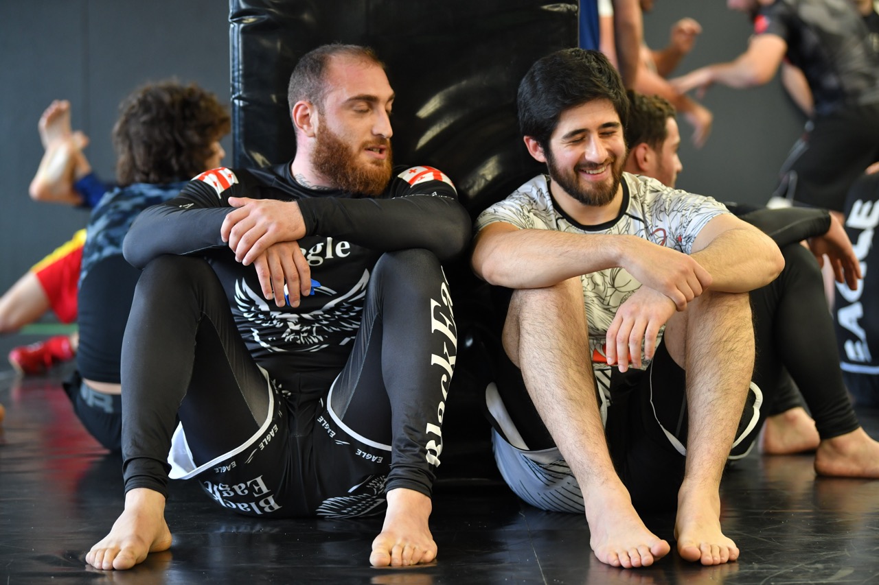 Technical grappling partners drilling safely during MMA camp
