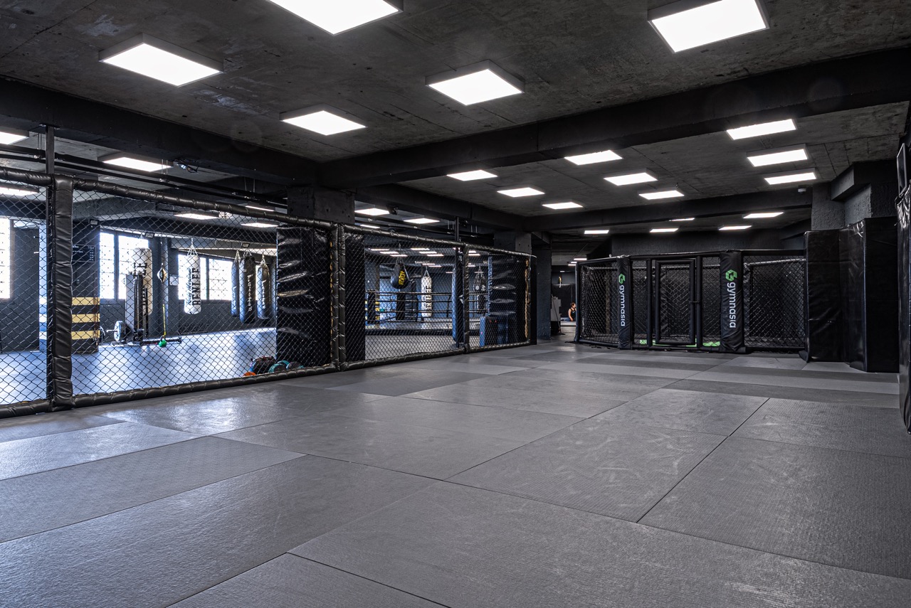 MMA training area with mats and octagon space at Gymnasia in Tbilisi