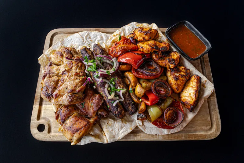 Grilled meat meal served for recovery during a full-board MMA camp